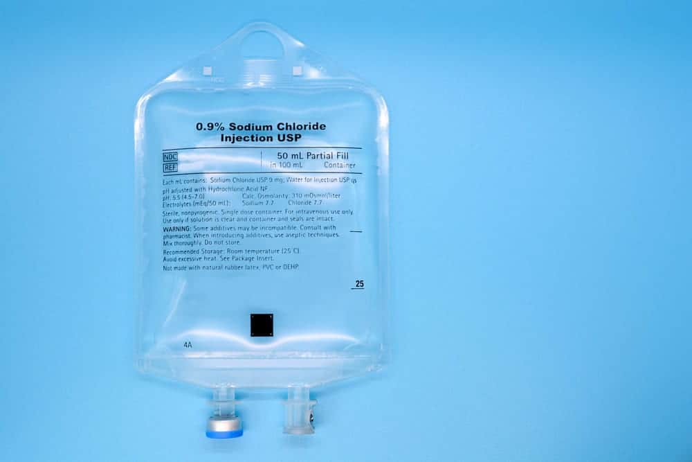 50ml saline IV bag on blue background