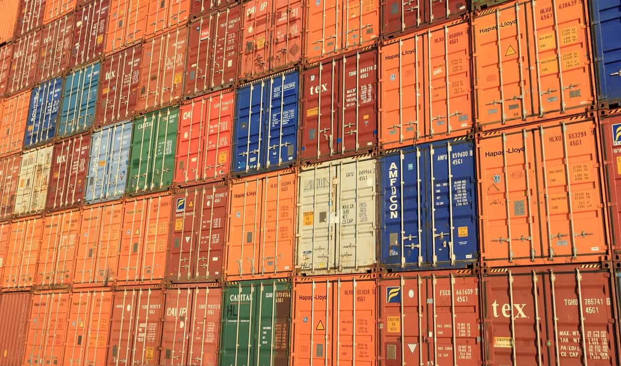 shipping containers stacked in a commercial port