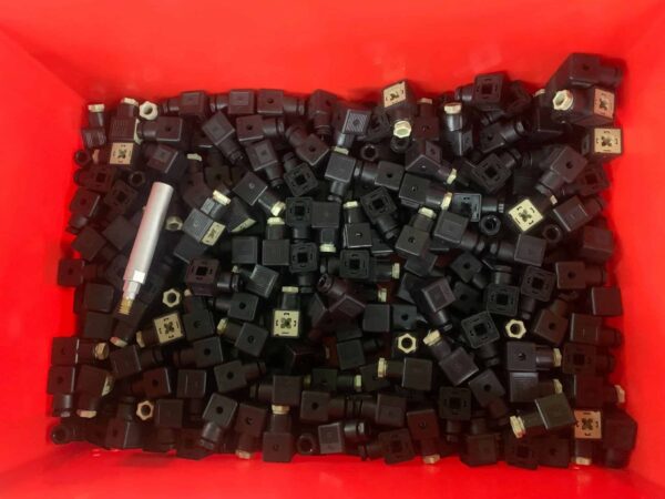 Red bin with dark plastic auto parts for bin picking automation