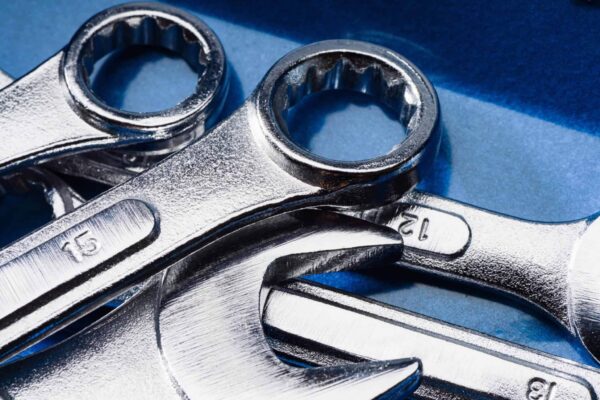 set of steel wrenches and spanners on a blue background
