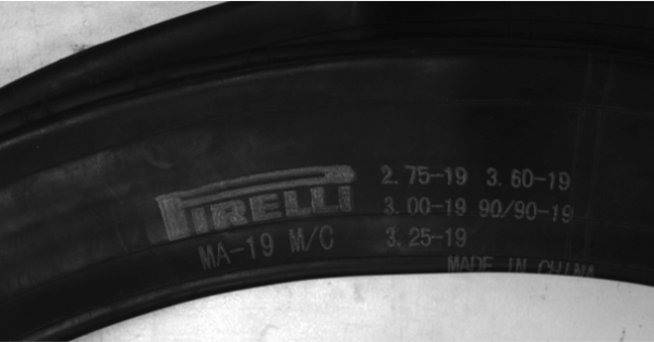 Blurry tire Identification number close up of a Pirelli tire Identification number (blurry text)