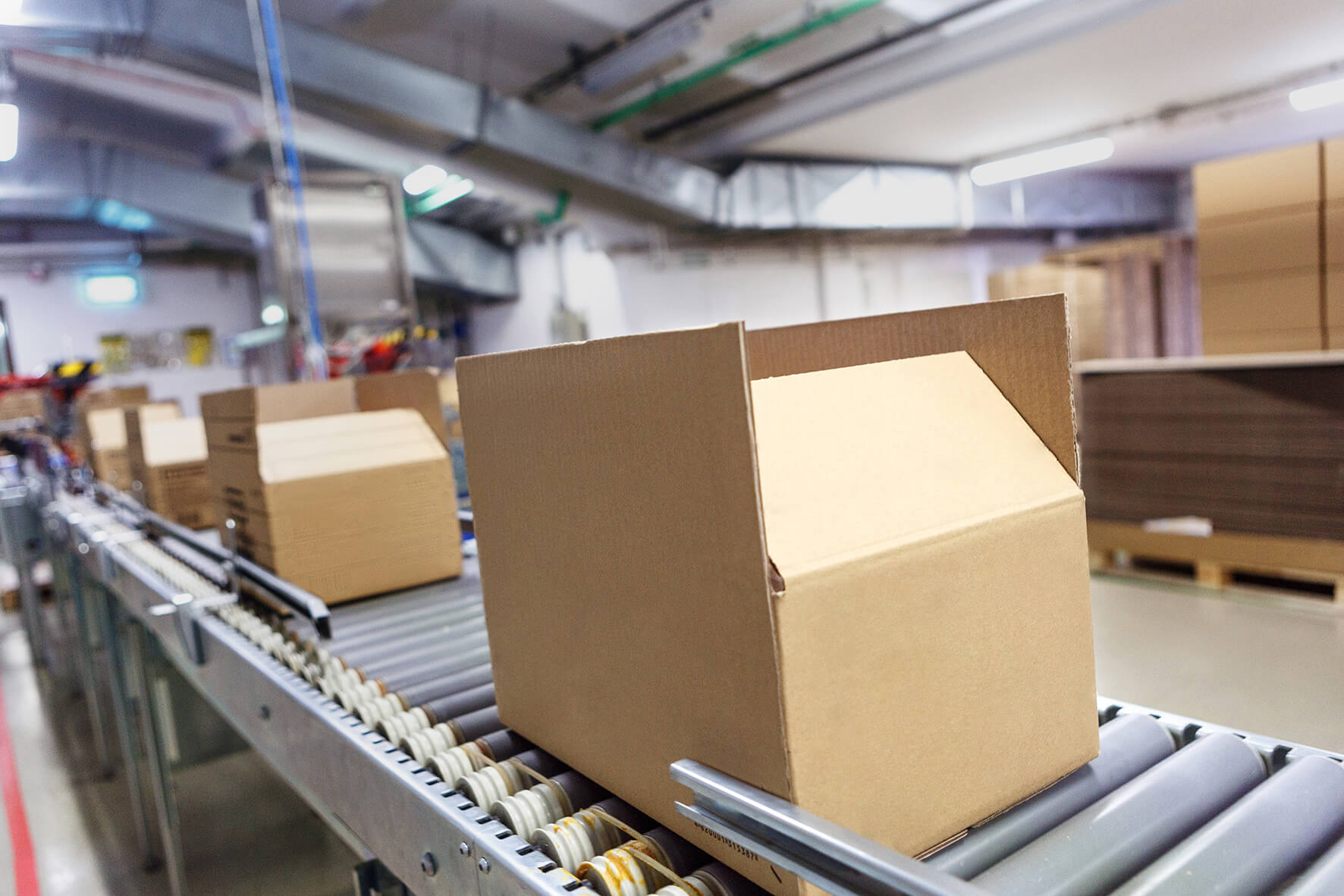 cardboard box moving along a conveyor in a warehouse